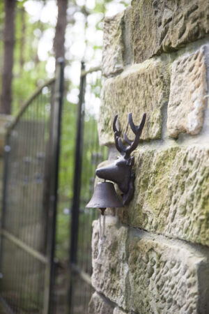 Stag door bell on brick wall